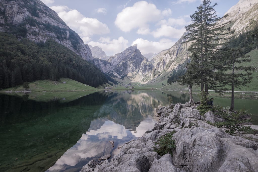 View of Seealpsee, a mountain lake surrounded by mountains in the Swiss Canton of Appenzell.