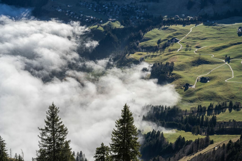 Clouds and for surrounding a small village in the alps