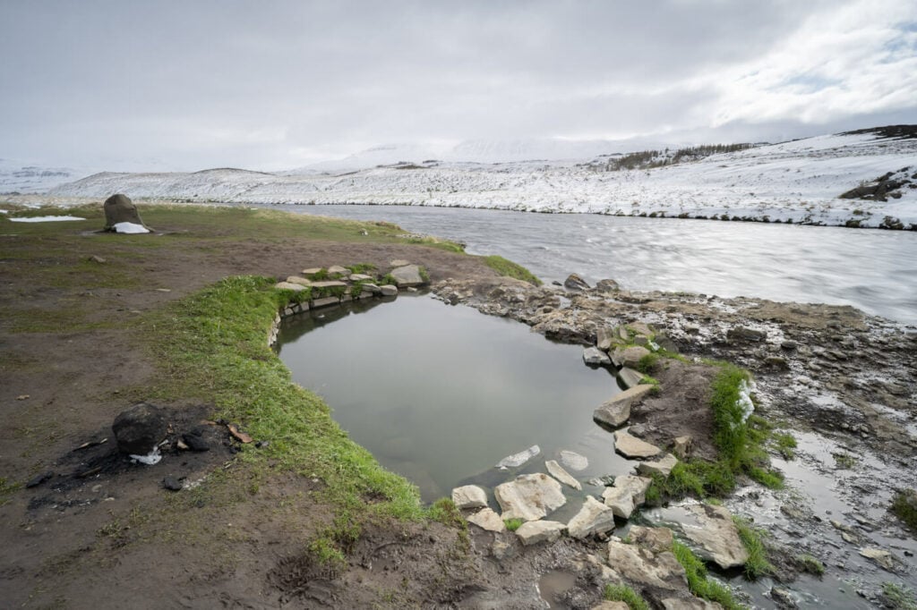 Fosslaug, a hot pool in northern iceland next to a river.