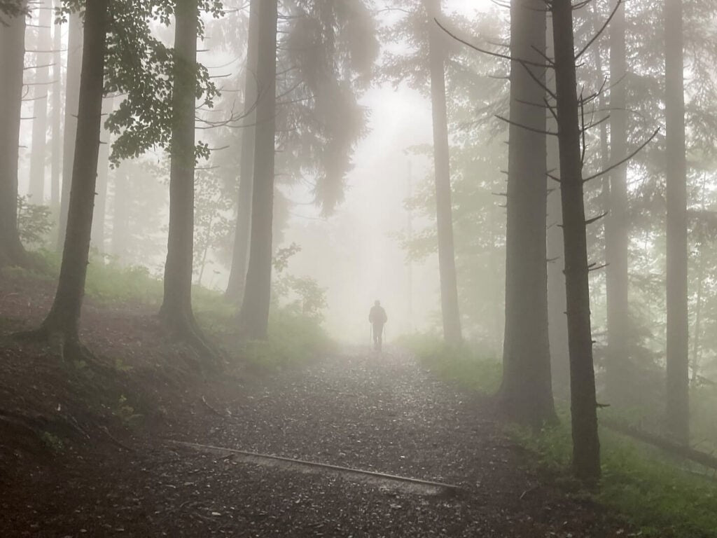 Man hiking in the fog on Mount Pilatus between Krienseregg and Frakmuntegg