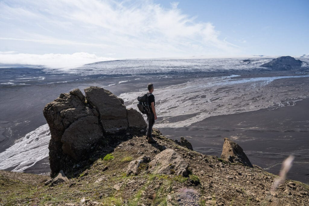 Hiker gazing at the outlwash plains of the Mýrdalsjökull glacier on a hike to Maelifell