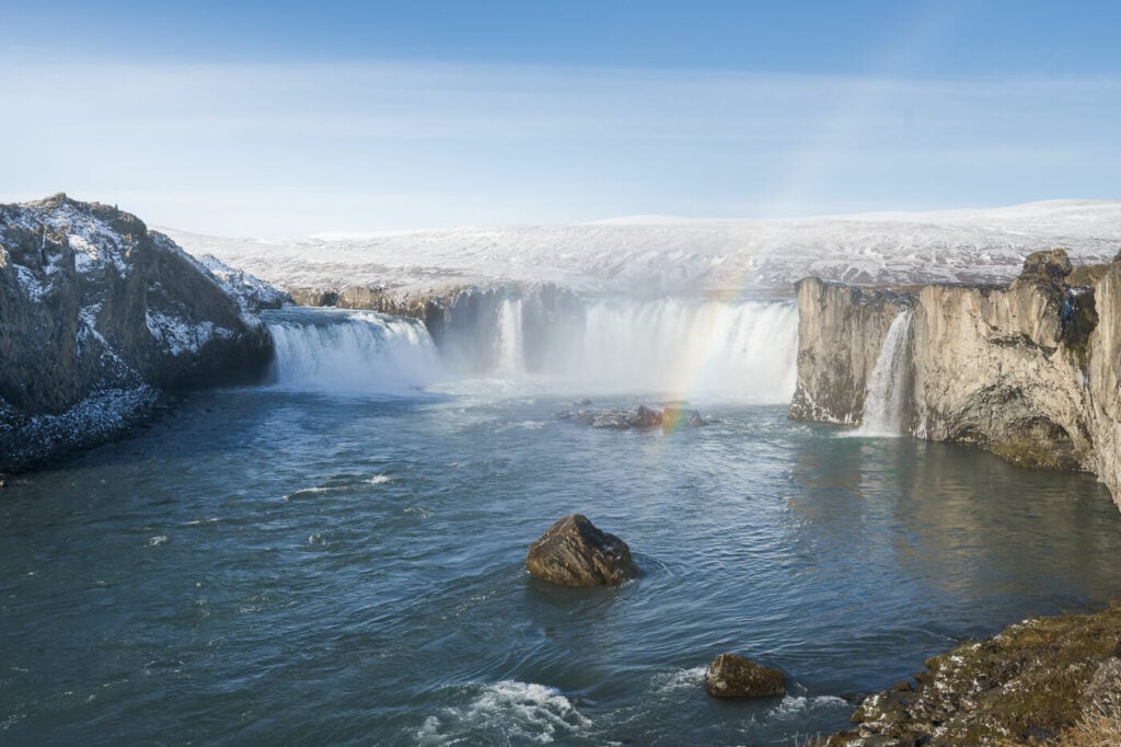 Godafoss on a sunny day with a rainbow