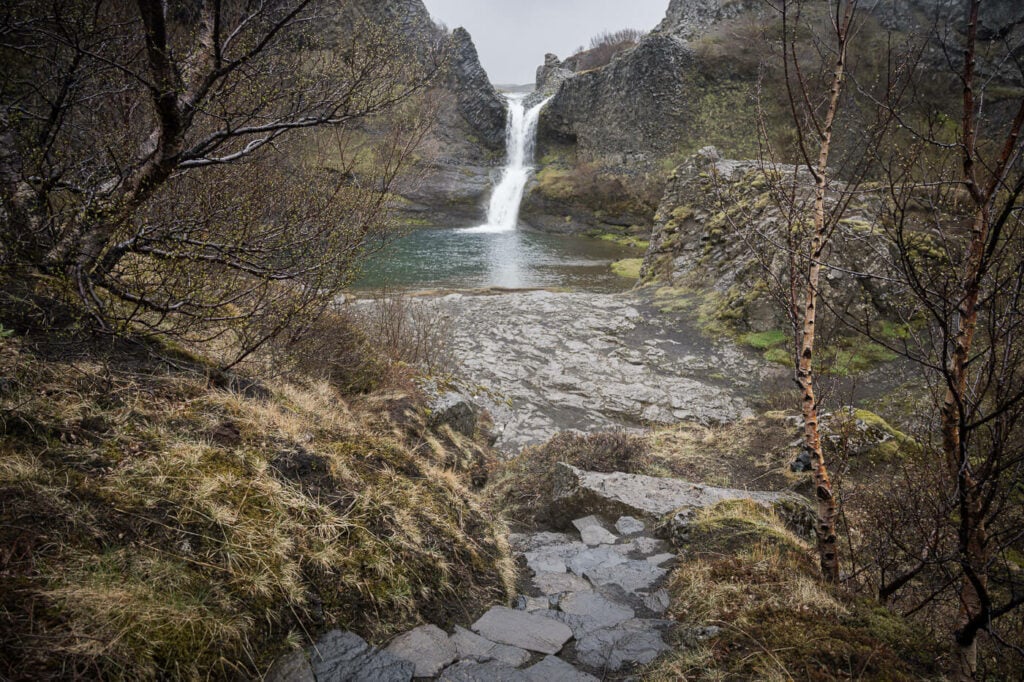 One of the Gjáin waterfalls on a cloudy and rainy day in late spring