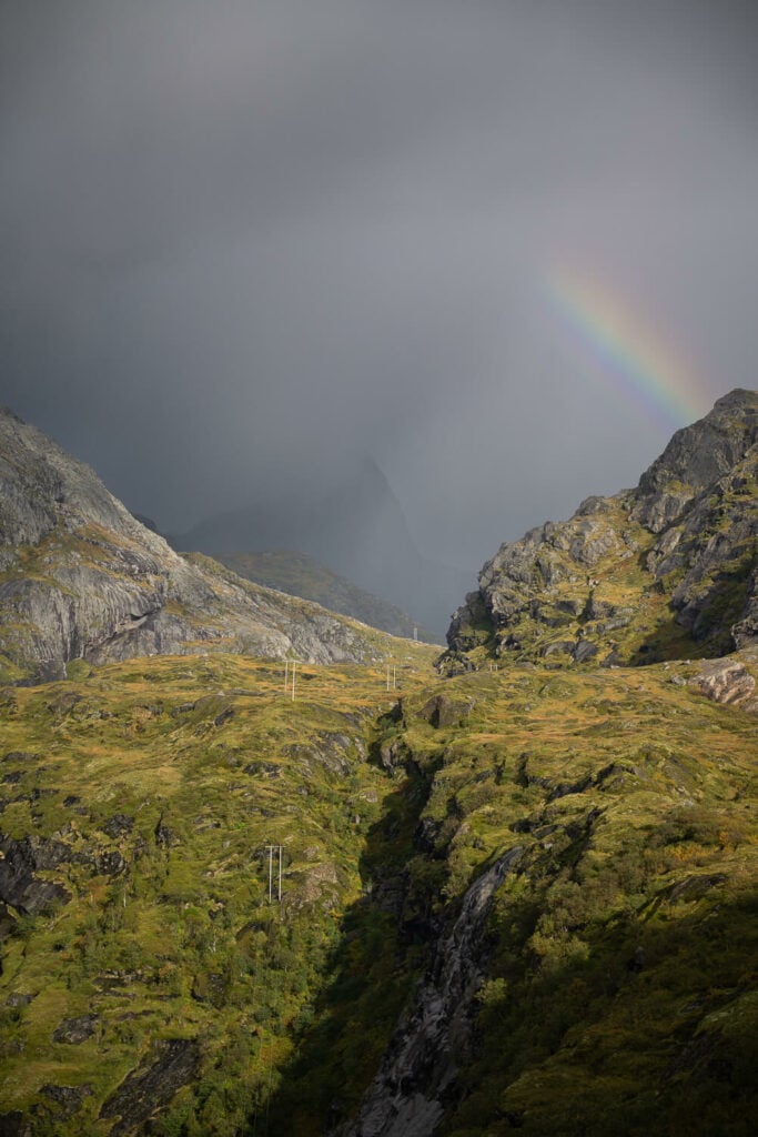 rainbow against dark clouds in the mountains of the Lofoten islands in Norway