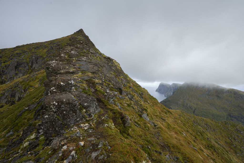 View of a mountain pean under a grey sky in arctic norway,.