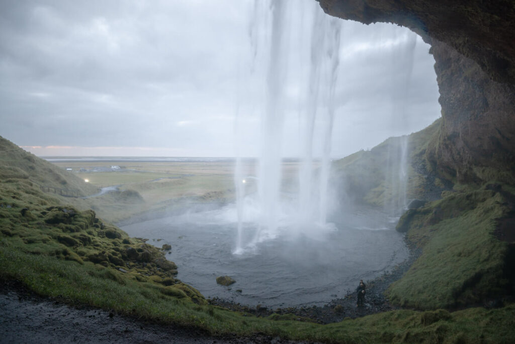 Waterfall viewed from behind a cave in Iceland