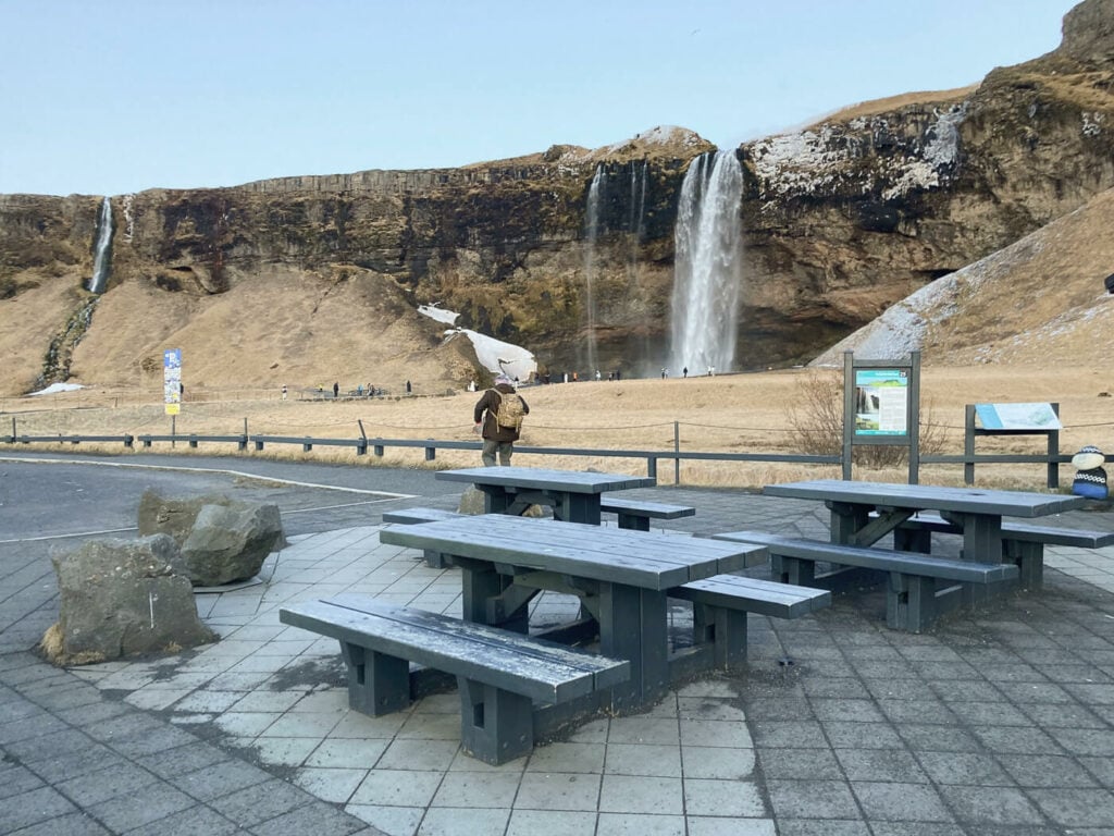 Picnic. tables next to a waterfall in iceland
