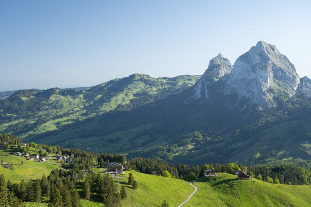 Grosser and Kleiner Mythen mountains in the early morning light under a cloudless blue sky.