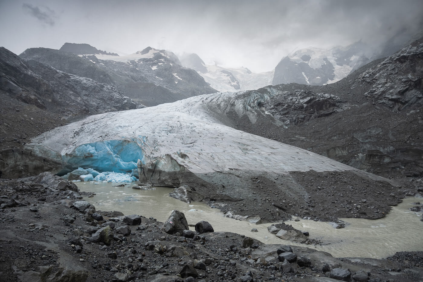 View of the morteratsch glacier tongue on a cloudy day where a piece of the glacier collapsed