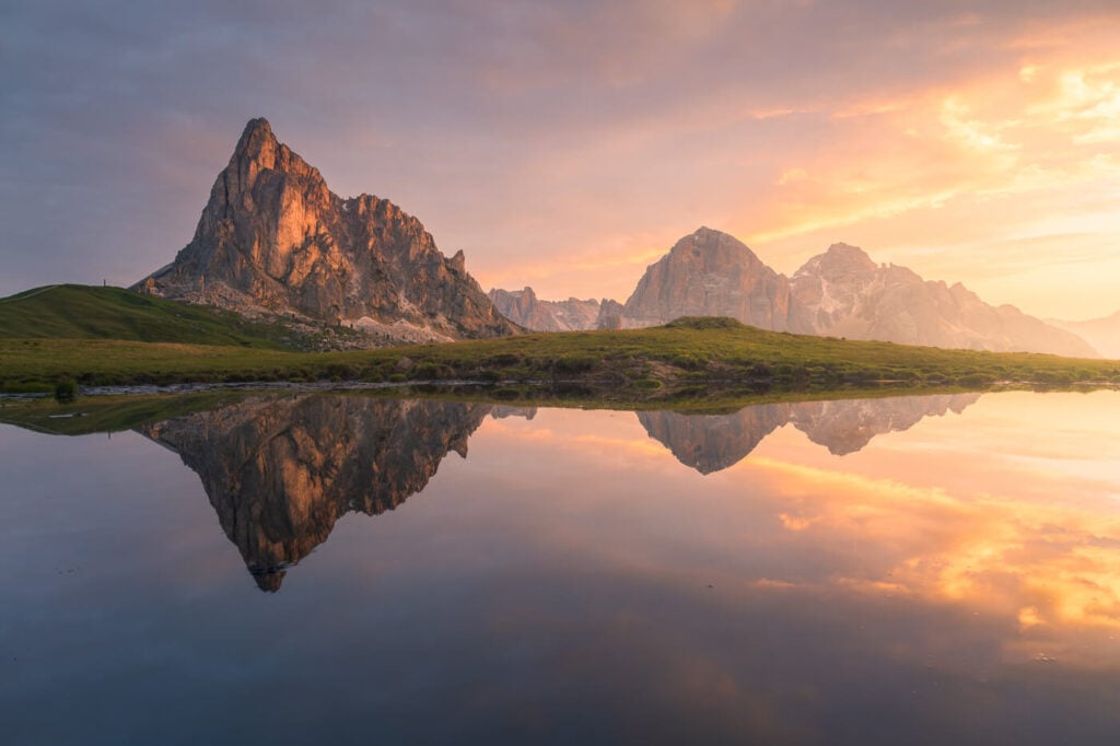 Ra Gusela pond reflection at sunrise with mountains reflecting above Passo Giau