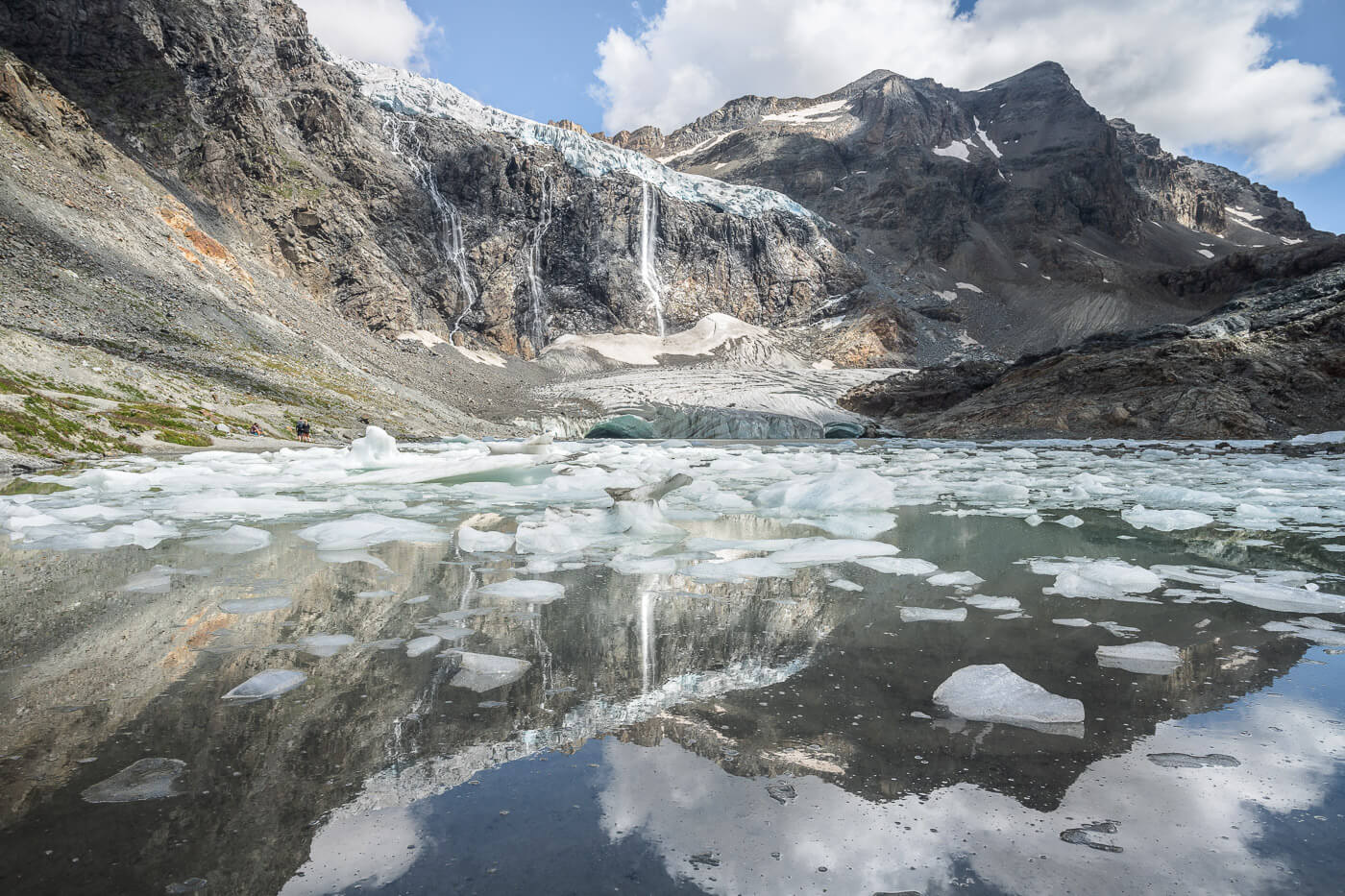 View of Ghiacciaio Fellaria with waterfalls and icebergs in a glacial lagoon