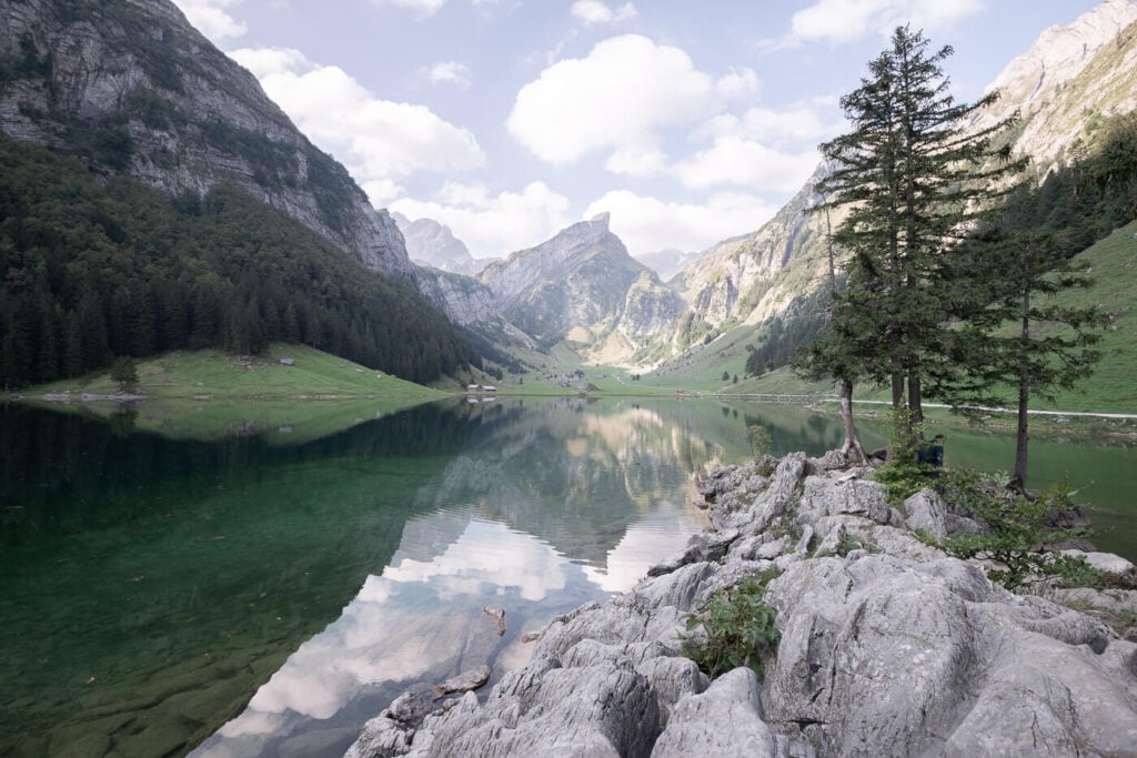 Seealpsee viewpoint with trees and rocks, overlooking the lake.