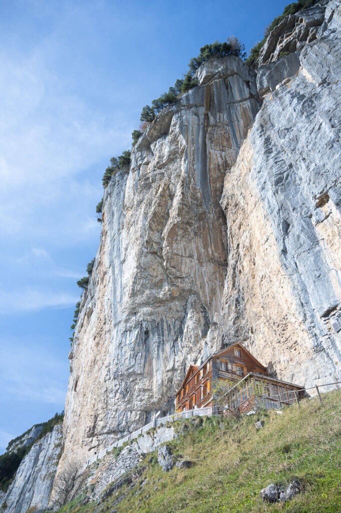 Äscher Berghaus, a mountain hut built on a cliff viewed from below