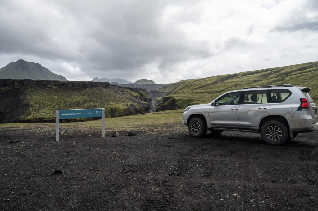 Car parked in Iceland near a canyon.