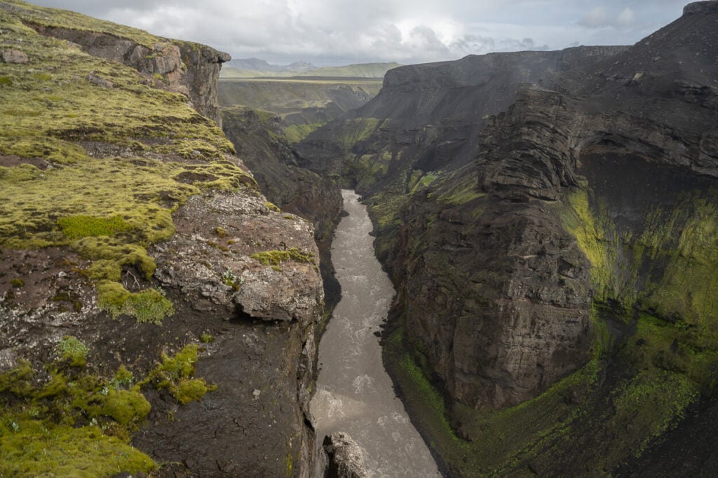 Markarfljót river flowing in between steep canyin cliffs