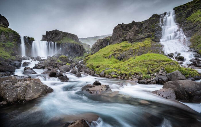 View of several waterfalls called vwestdalsfossar on the sides of a small ravine