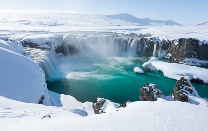 View of a waterfall in Iceland in winter with snow all around