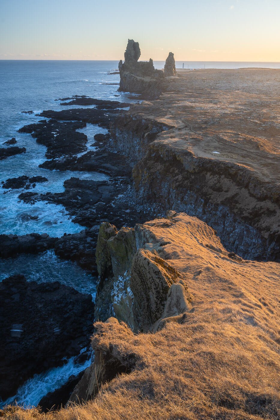 Sunset at Lóndrangar in Iceland in March, from the hiking trail above the coast.