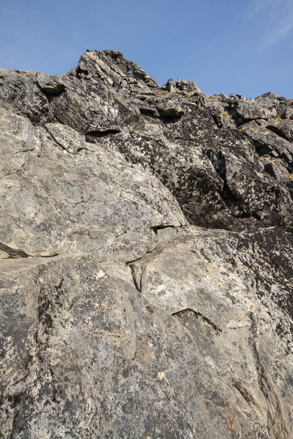 Vertical wall of rock part of the climb to Breidtinden.