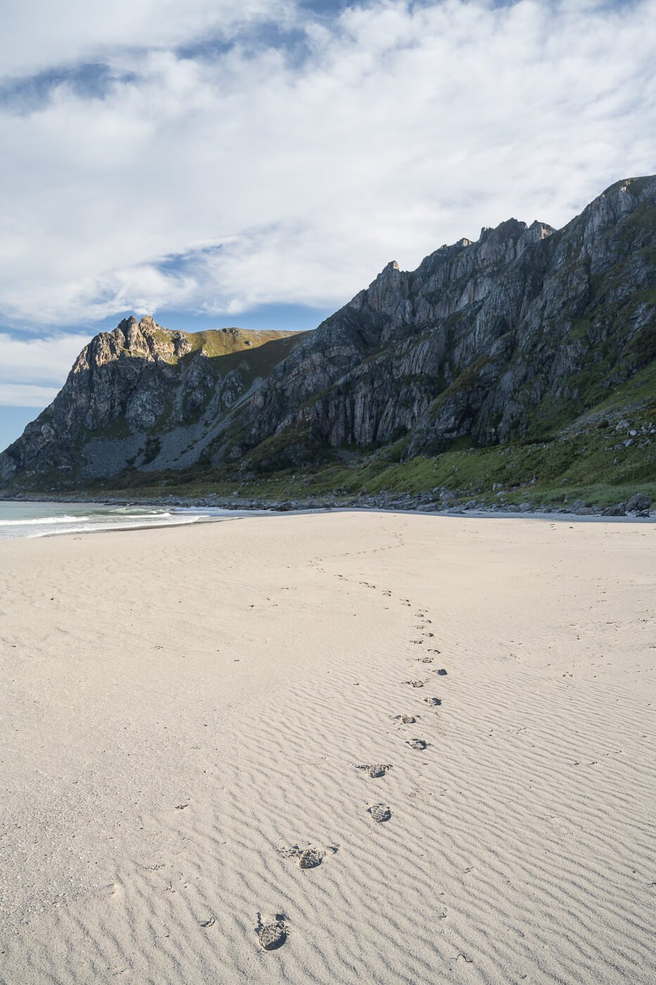 footprints in the sand of Otervika beach.