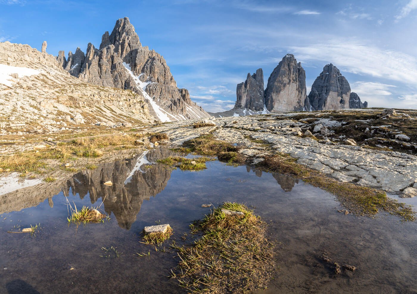 Tre Cime and monte paterno reflecting in a puddle