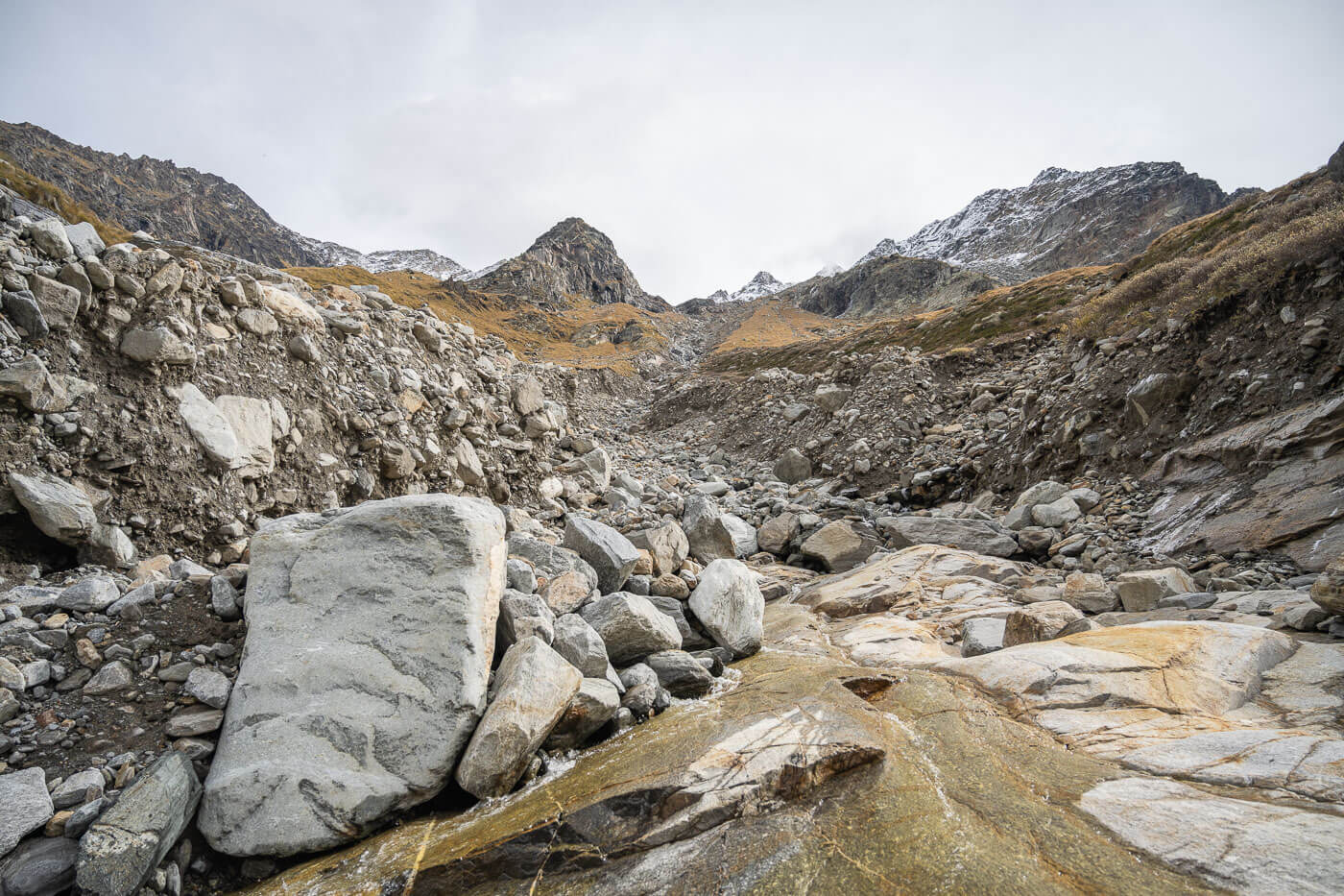 Devastation on a mountain where a flood stripped the ground down to bedrock.