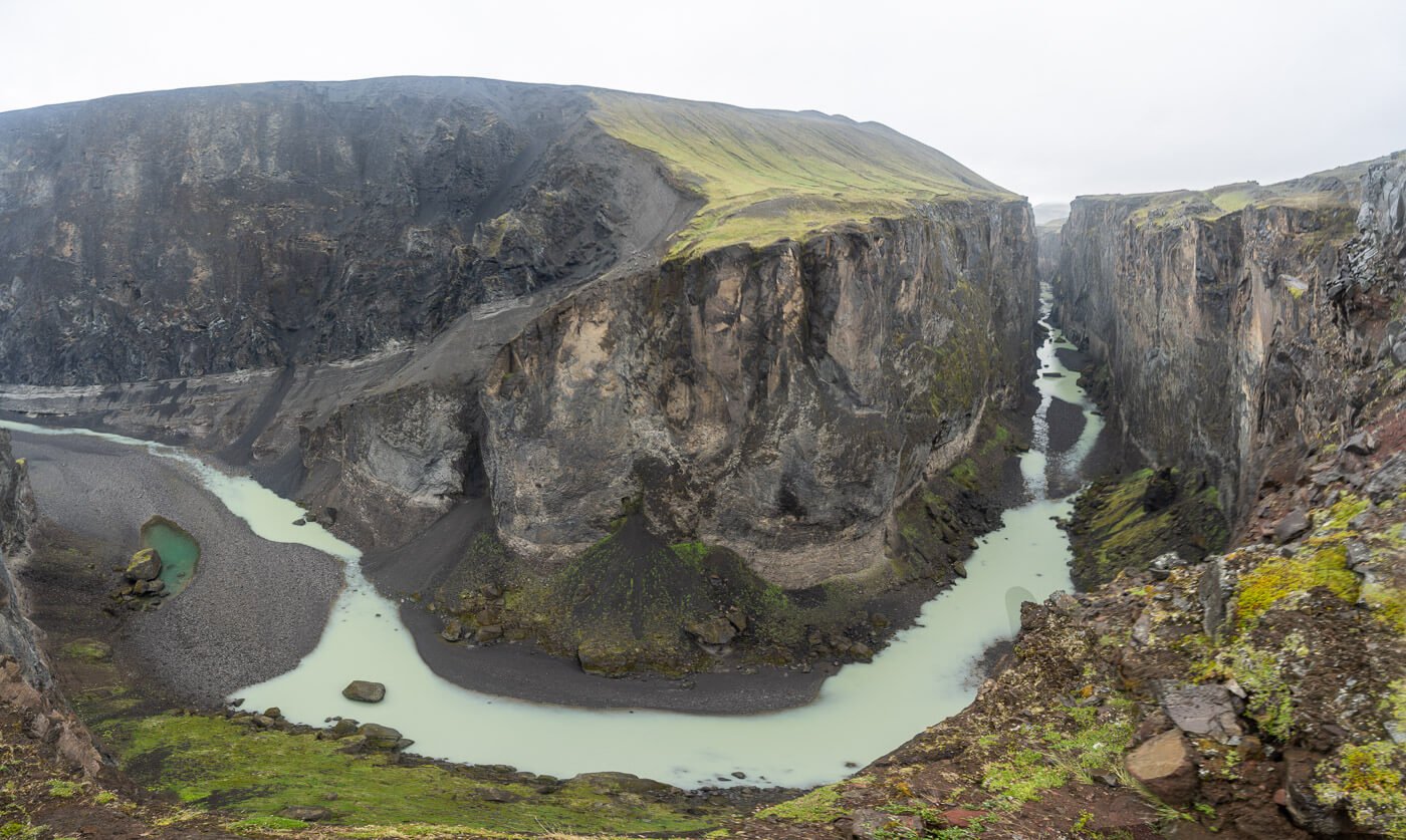 180 degrees panoramic image of the Hafrahvammagljufur' Canyon, with the river bending in the middle