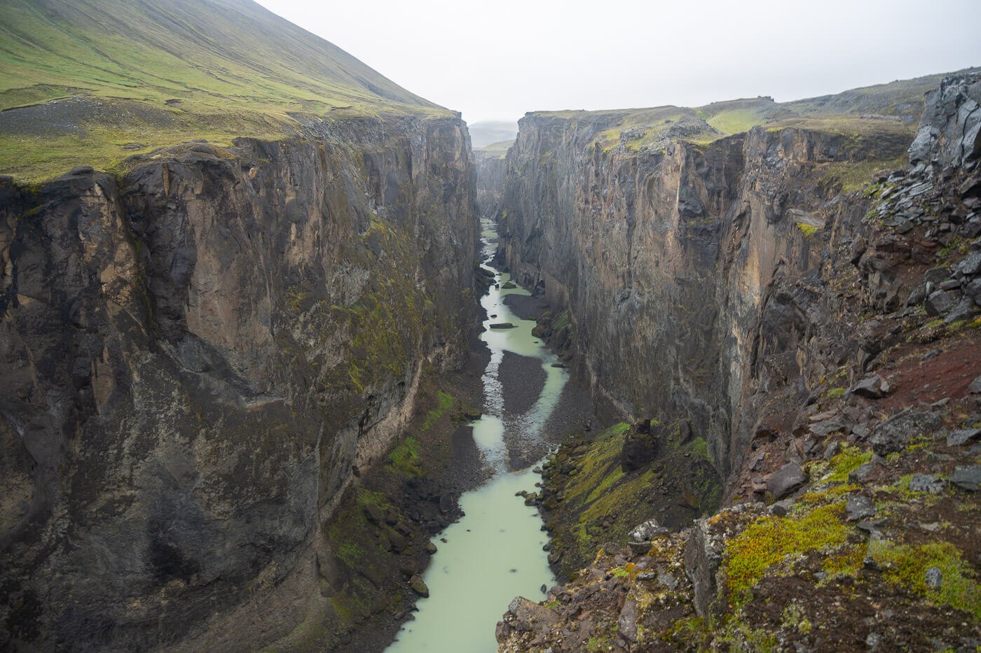 Hafrahvammagljufur Canyon in east icelany with a layer of fog above it.