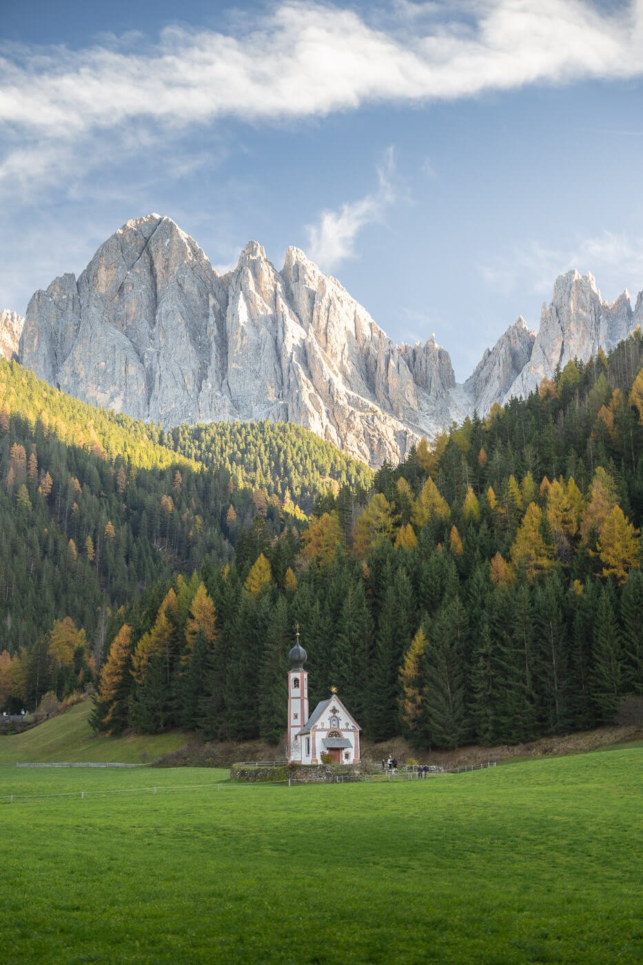 Saint John in Ranui Church with the dolomites in the background.