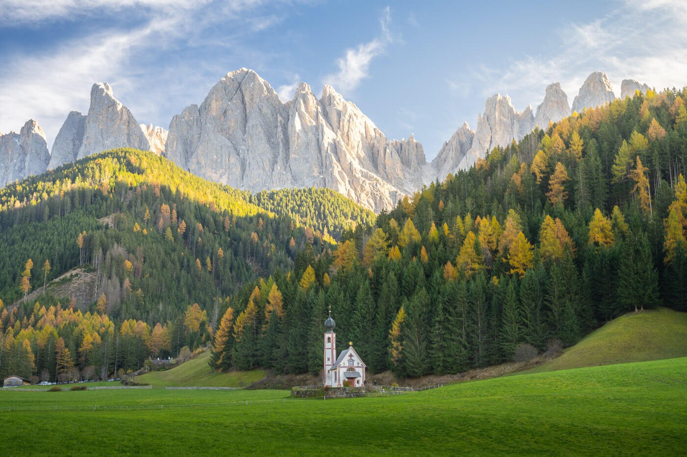 View of the St. John in Ranui Church in the dolomites, on a sunny autumn day.
