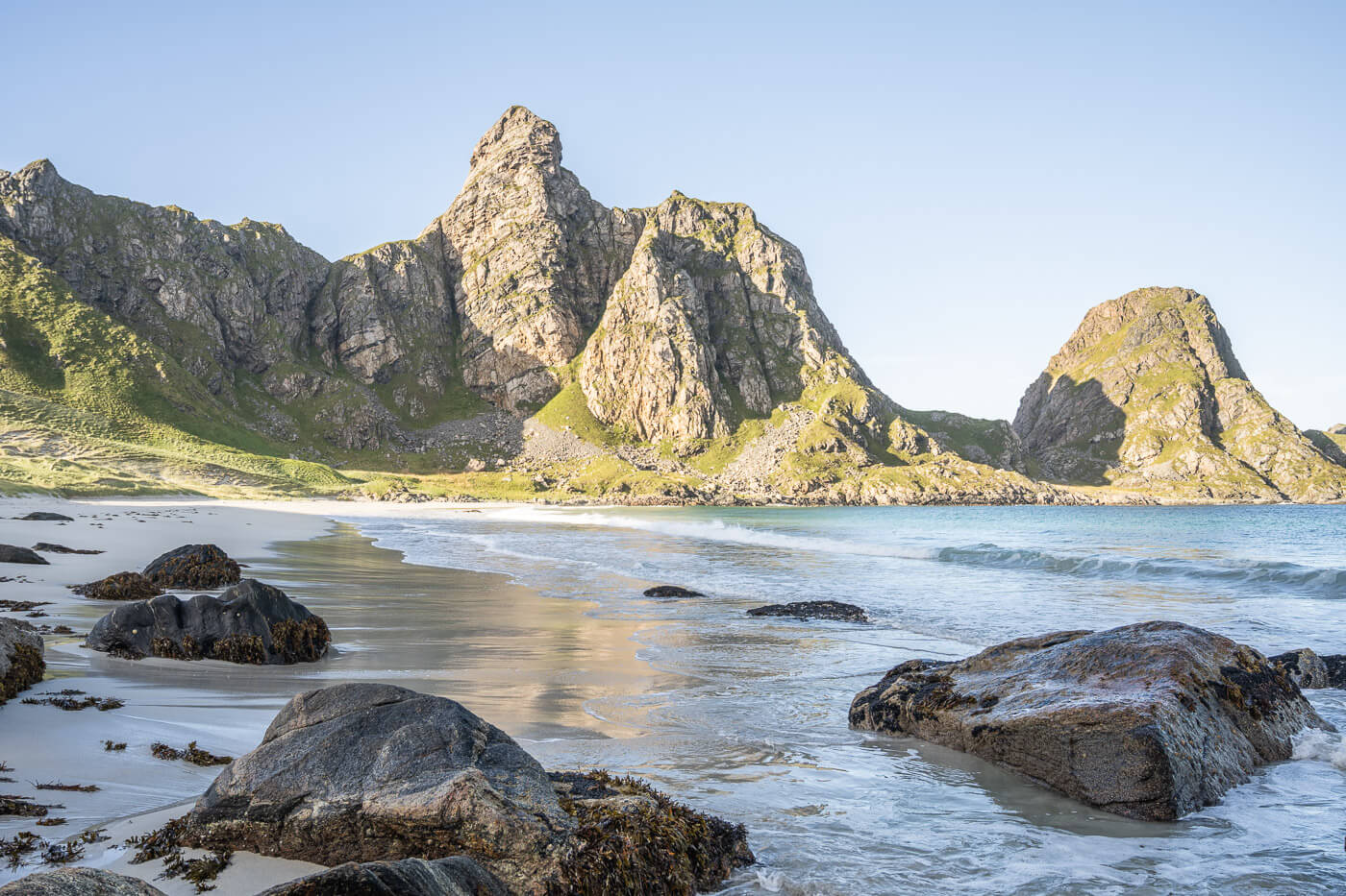 Rocks on a white sand beach in Andoya.