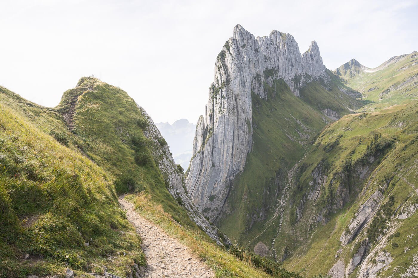 View of a hiking trail above Saxer Lücke, with view of the Kreuzberge mountain in the background.