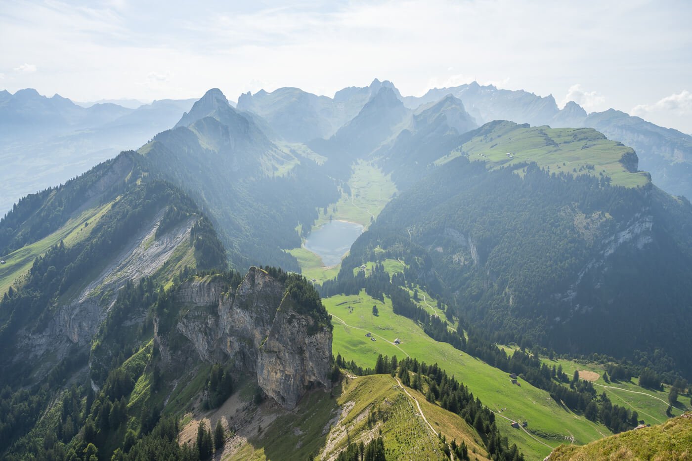View of the landscape at the end of the Hike to Hoher Kasten, with view of the Alpstein mountains and its green pastures