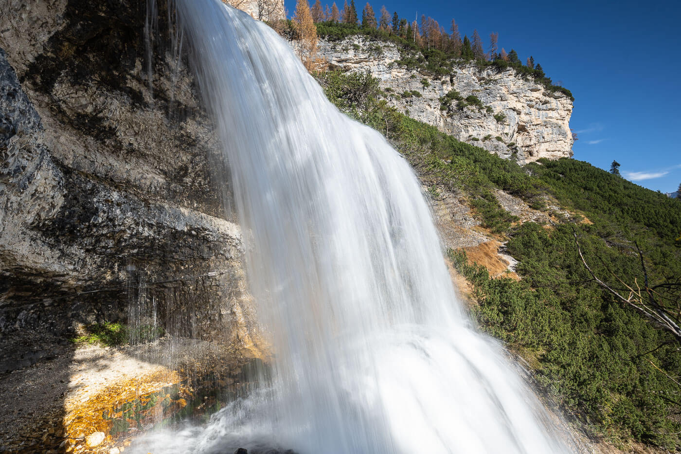 Upper step of the Sbarco de Fanes waterfall in the Dolomites, a waterfall you can walk behind