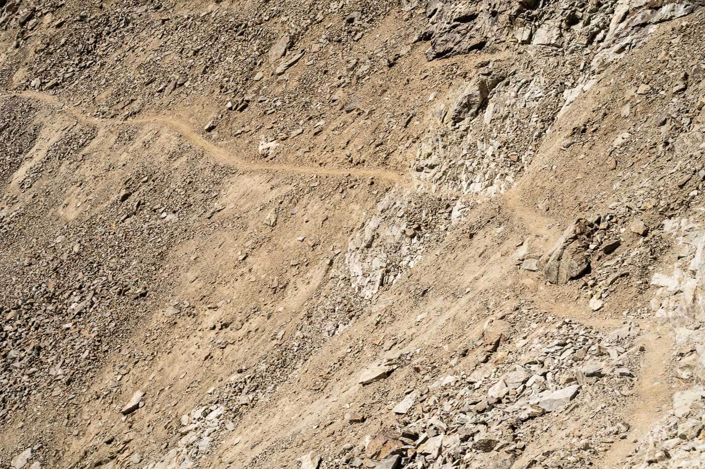 Exposed trail on a rocky mountainside around Diavolezza