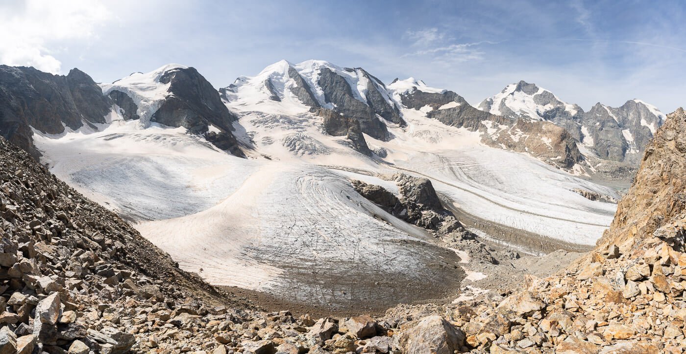 Panoramic view of the Piz Bernina massif and glaciers on a sunny day