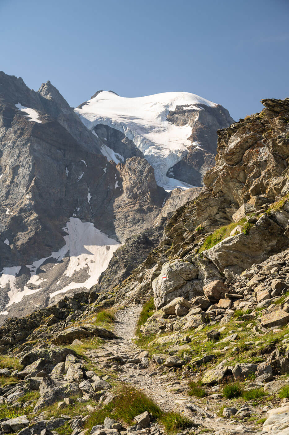 View of a hiking trail that leads to Diavolezza with glacier in the background.