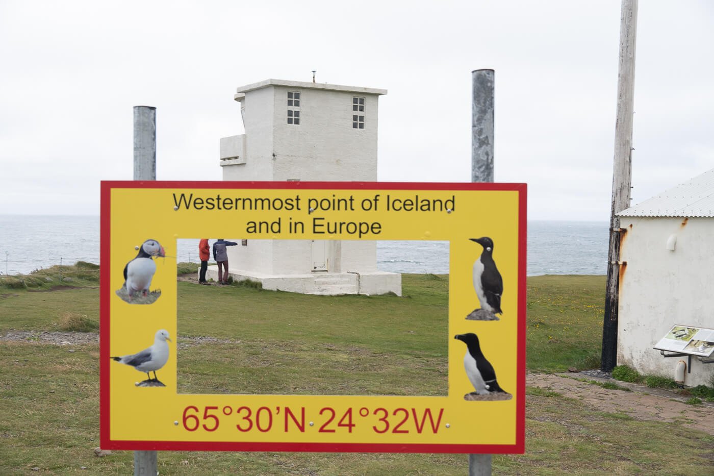 Photo of the Westernmost point in Iceland with a lighthouse in the background.