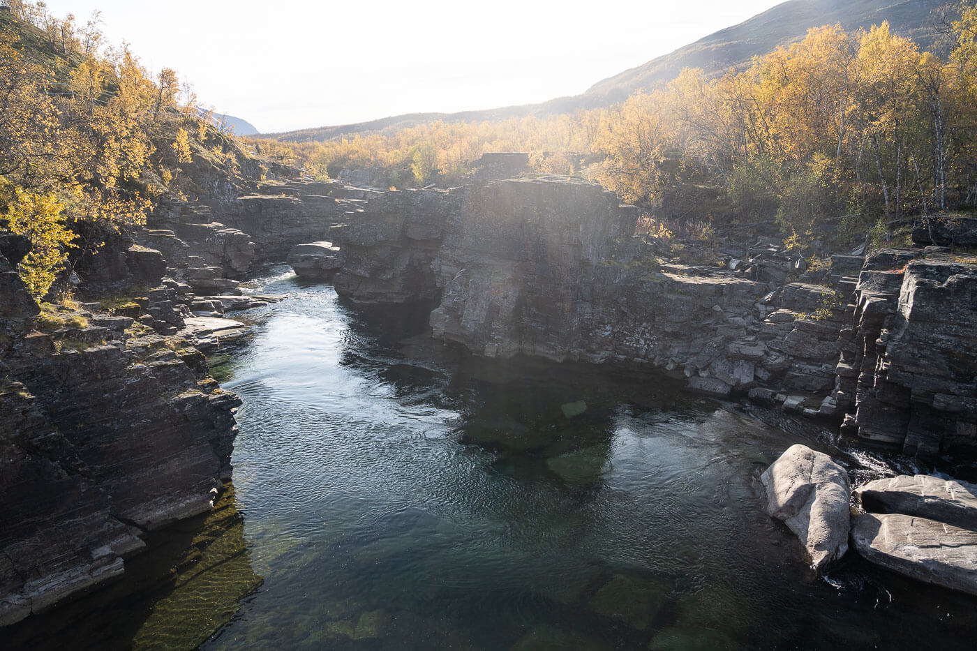 Calm waters of the Abiskojok river viewed from the Njakajaure trail