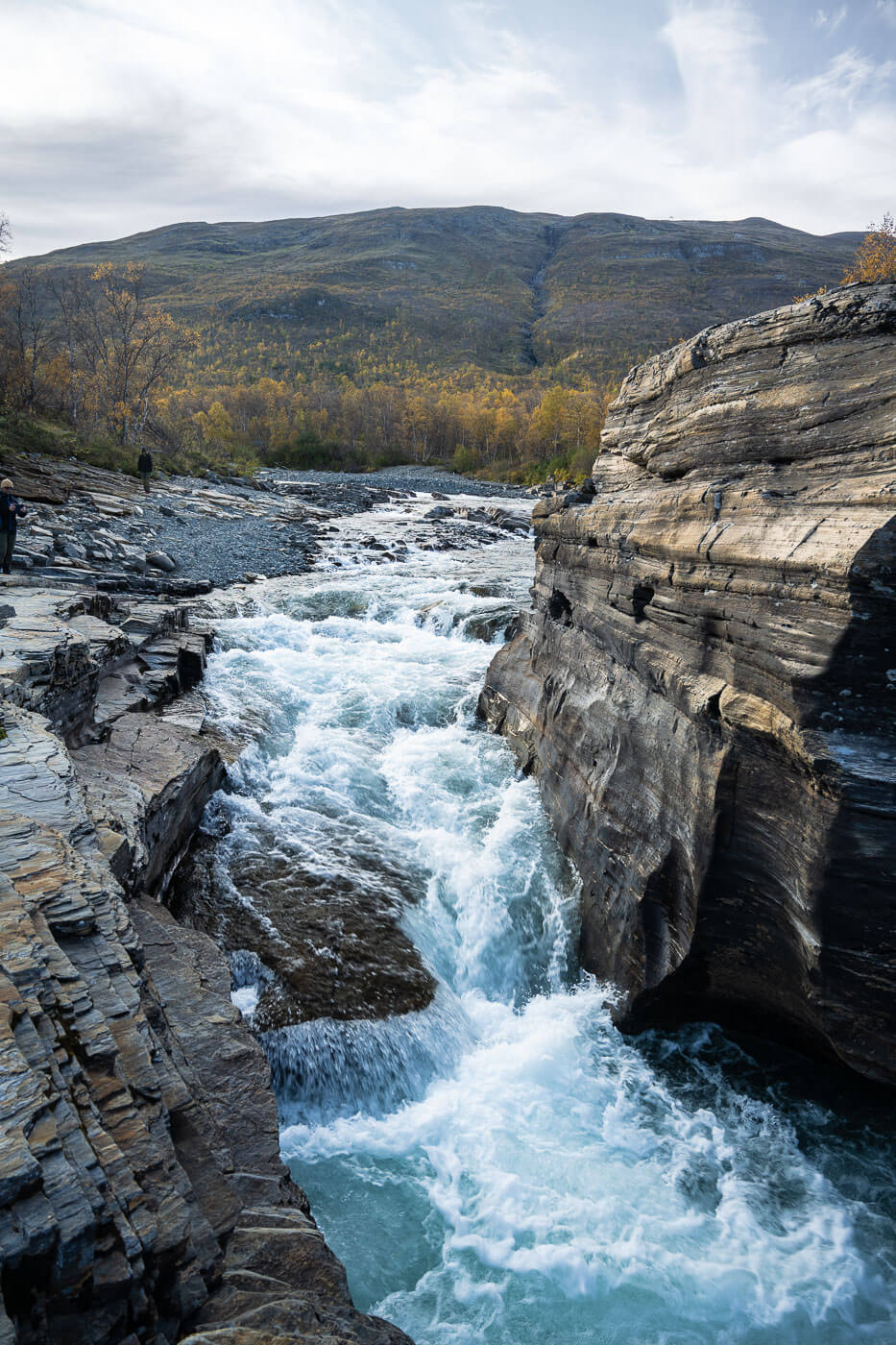 Abiskojok river forming a sm all waterfall