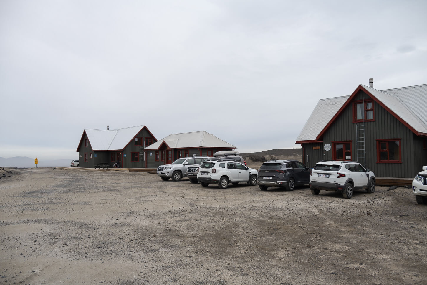 Dreku hut at Askja with Dacia Dusters and other cars parked.