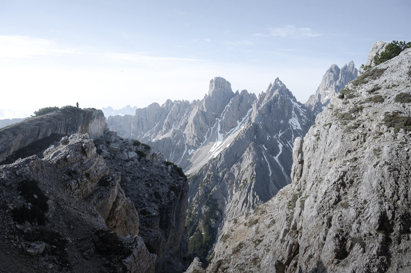 Hiker in the dolomites looking at the landscape