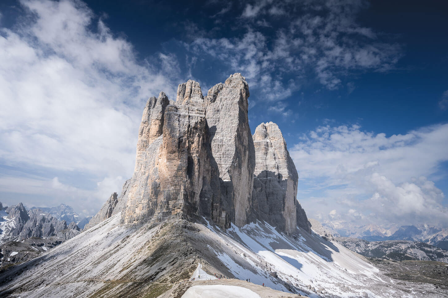 View of Drei Zinnen from Forcella Lavaredo on a sunny day with blue skies.