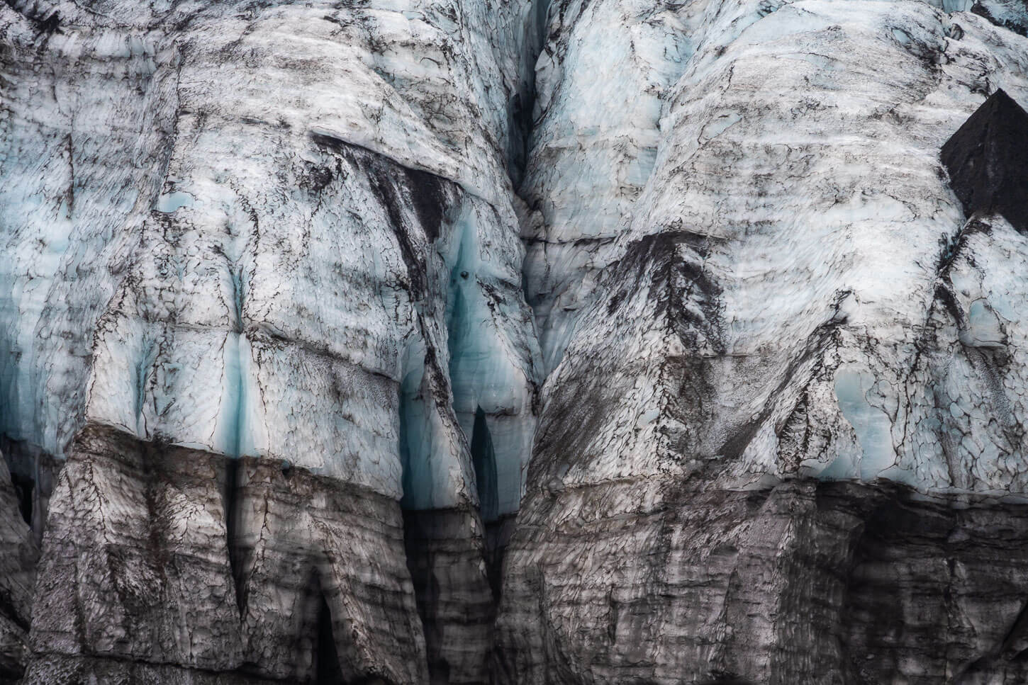Details of the layers and cracks of a glacier front.