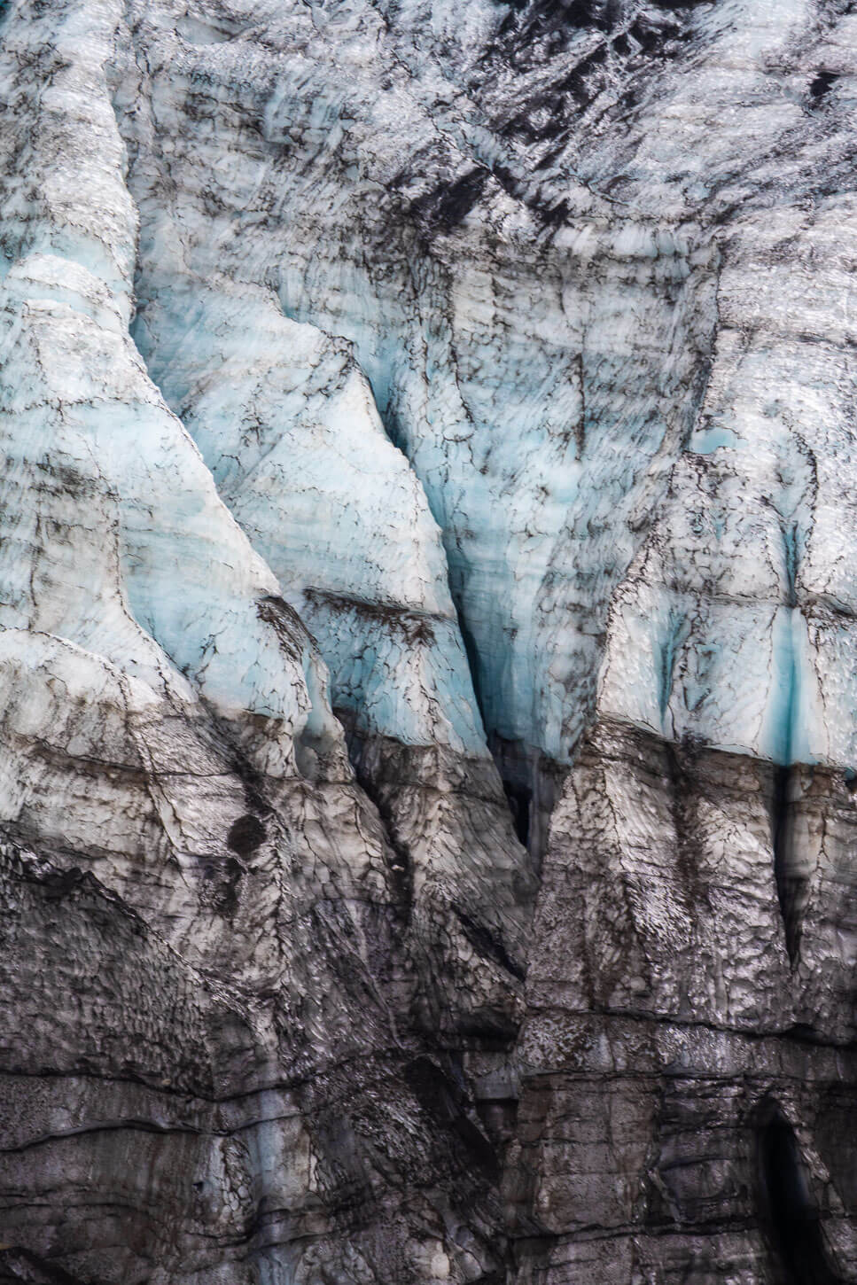 Upclose view of the Gígjökull glacier tongue revealing the texture and blue color of the ice.