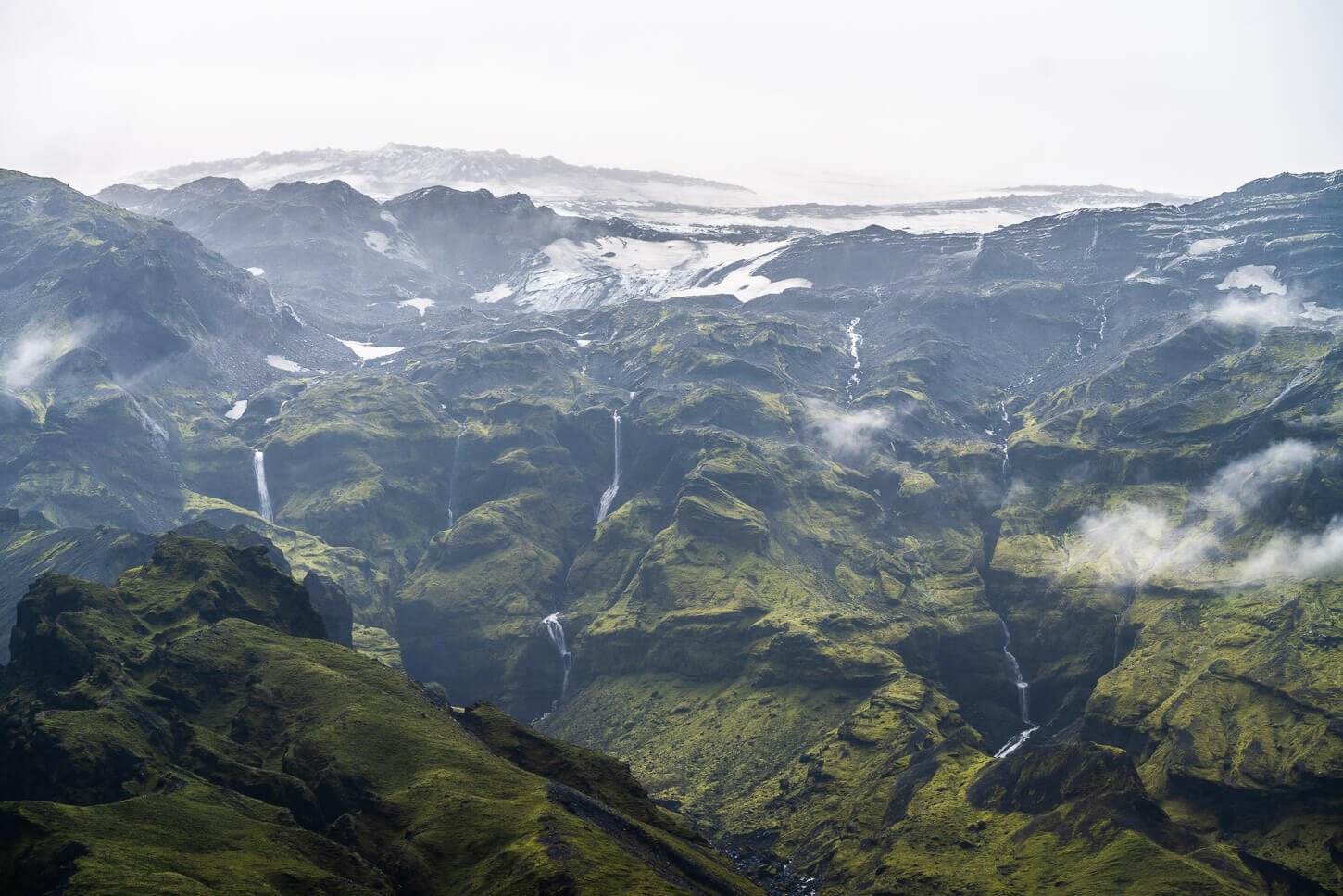 View of a valley in Thorsmor with several waterfalls faling from a glacier near the Gígjökull Glacier