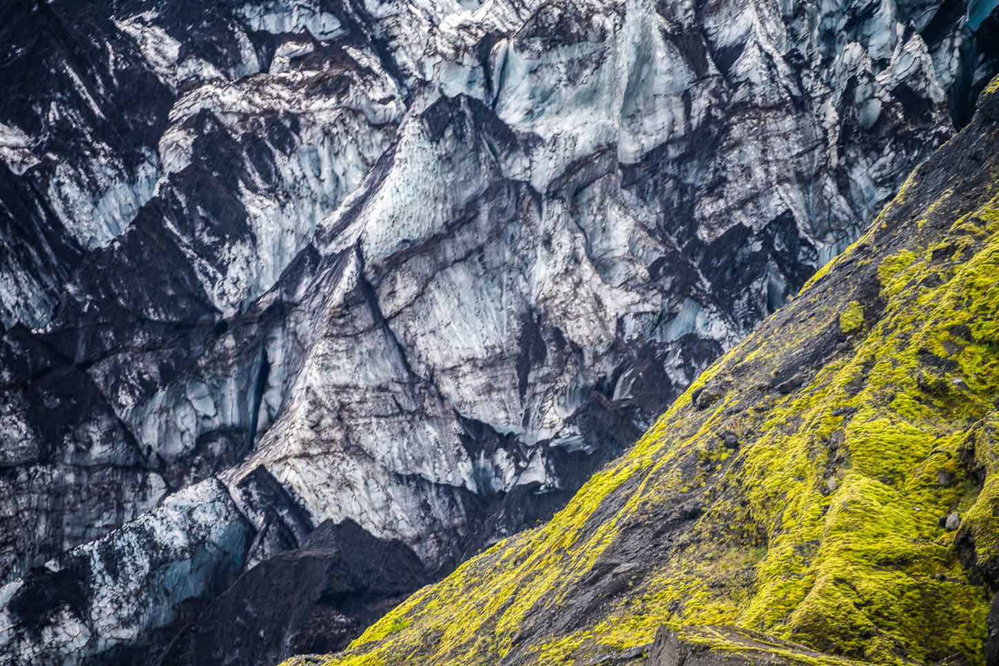 detail of a glacier covered in dark dust 
