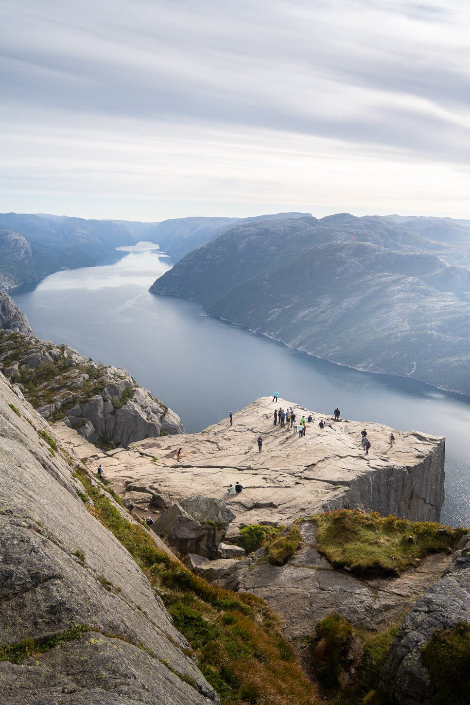 Preikestolen upper viewpoint where you can see the pulpit rock from above with people standing on it.