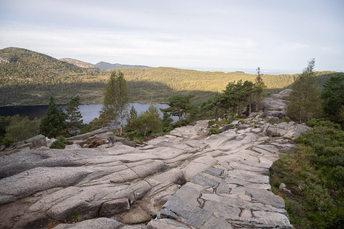 A stone-paved section on the trail to Pulpit Rock and views of the landscape around it can be admired during the hike.