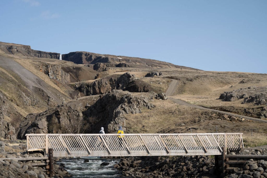 Hengifoss bridge viewpoint with hikers on it.